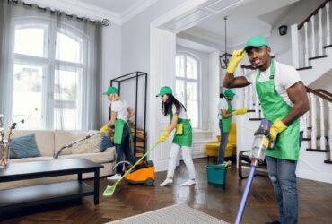 Mixed race janitors doing spring cleaning of house
