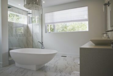 Modern interior design luxury bathroom with bath and glass walled shower