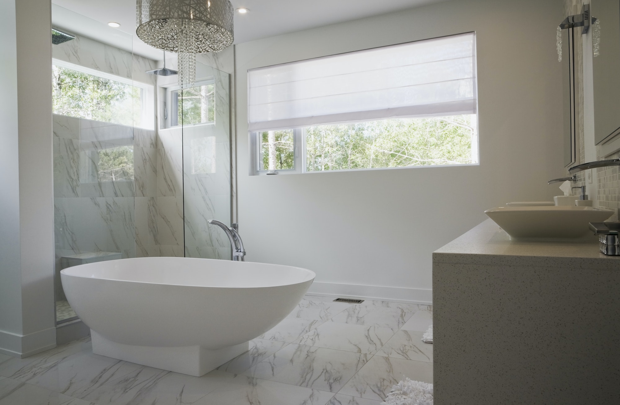Modern interior design luxury bathroom with bath and glass walled shower