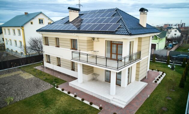 Modern residential house with solar panel system on roof.