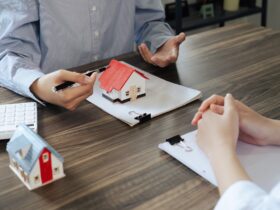 Real Estate Agent explain Property insurance and security concept about house to client before sign