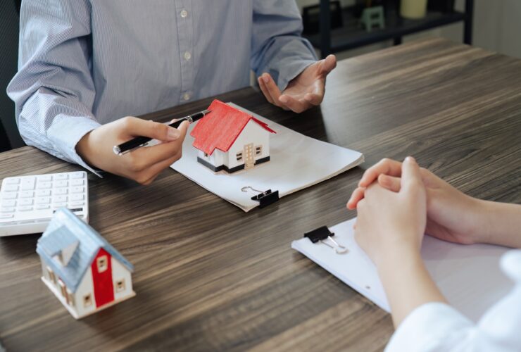 Real Estate Agent explain Property insurance and security concept about house to client before sign