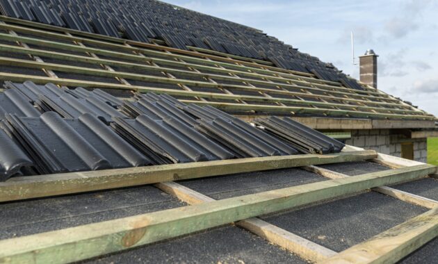 Roof ceramic tile arranged in packets on the roof on roof battens. laying tiles on a boarded roof.