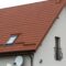 Roof of a new house made from yellow roofing tiles