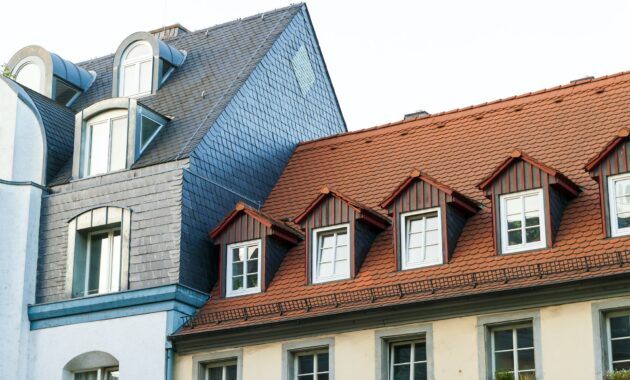 Roofs of old houses with roof windows and orange roof tiles in German city