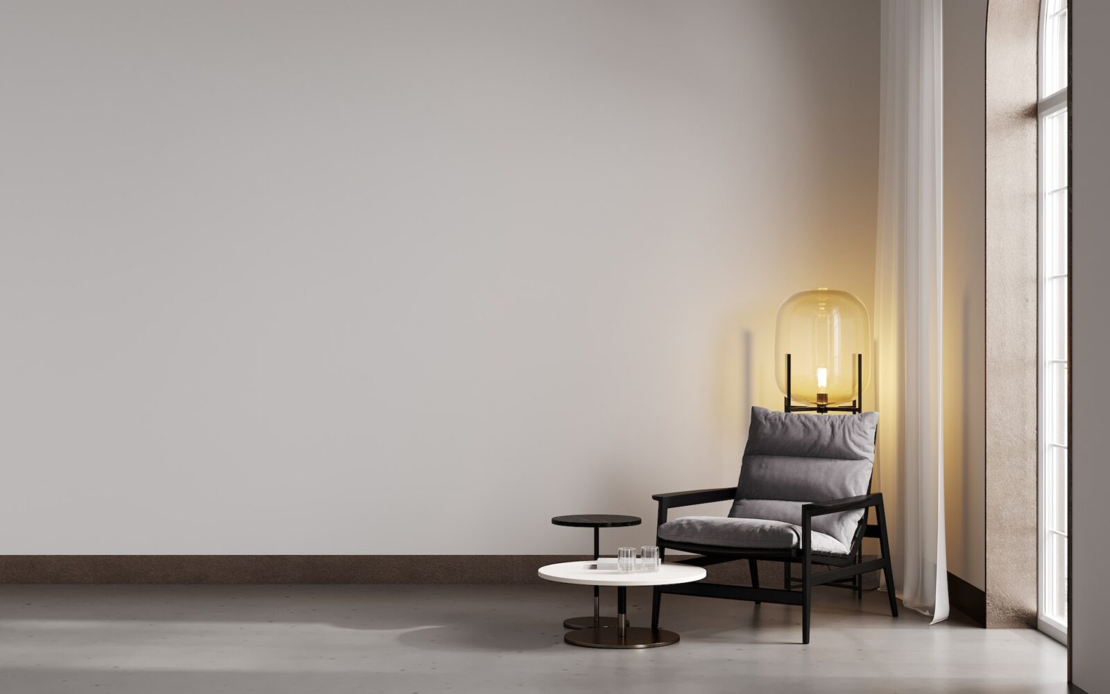 Room with beige wall and concrete floor with gray modern armchair