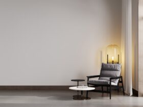 Room with beige wall and concrete floor with gray modern armchair