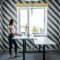 Standing desk for work from home or in office. Young woman programmer working