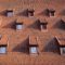 Traditional roof with windows covered by ceramic tiles