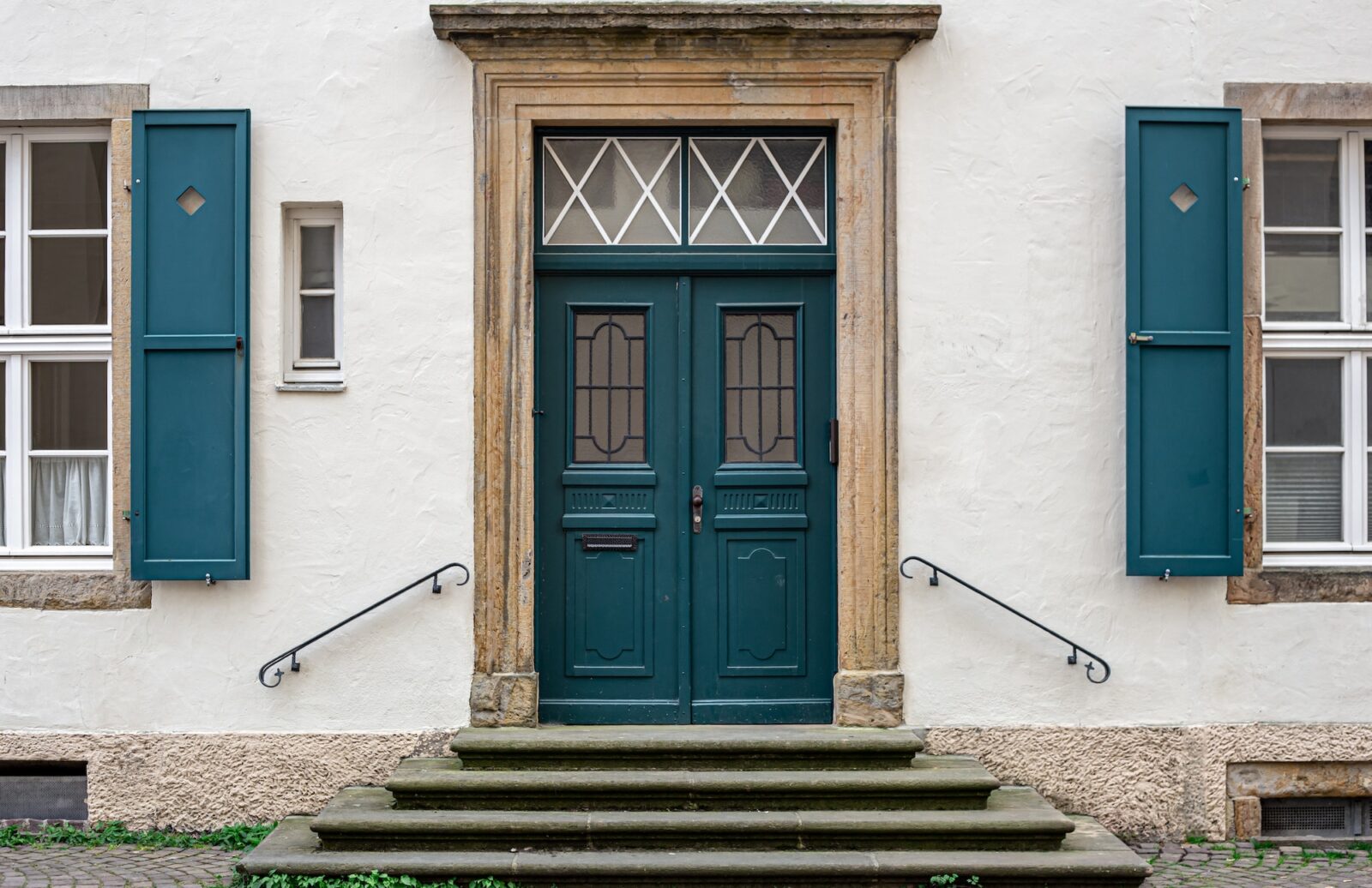 Vintage old doors and windows on the facade of the house.