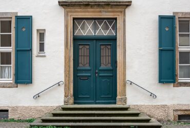 Vintage old doors and windows on the facade of the house.
