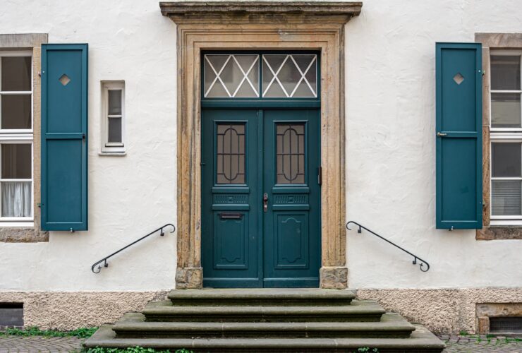 Vintage old doors and windows on the facade of the house.