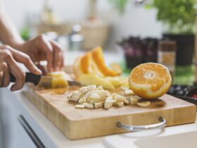 Woman preparing fruit on chopping board
