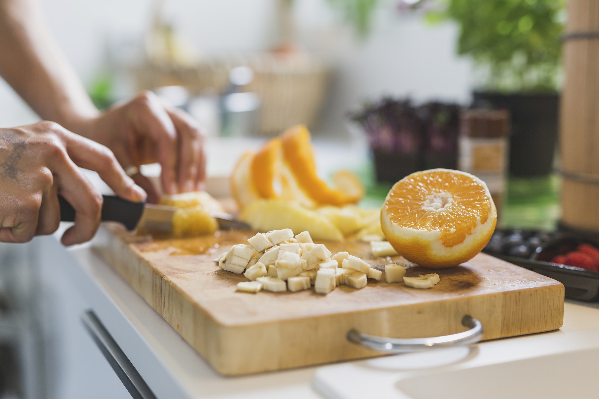 Woman preparing fruit on chopping board