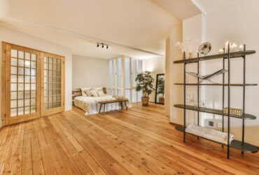 A luxurious huge bedroom with a wooden floor