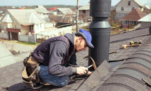 A Professional Master (roofer) With Hammer Repairs The Roof.