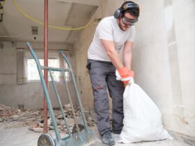 Builder Collecting Construction Debris In A Bag A 2022 08 16 22 34 23 Utc