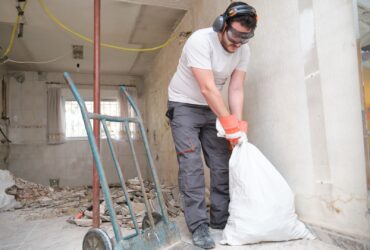 Builder Collecting Construction Debris In A Bag A 2022 08 16 22 34 23 Utc