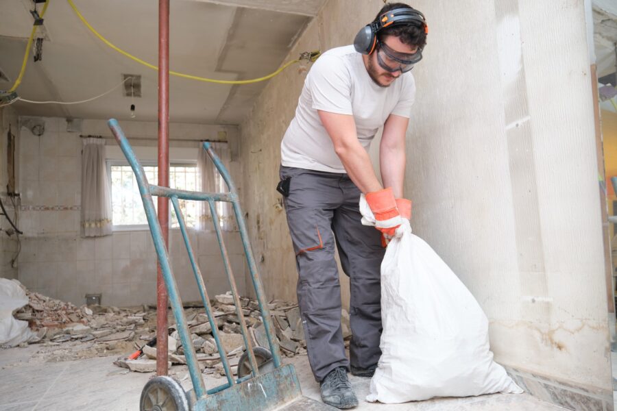 Builder Collecting Construction Debris In A Bag A 2022 08 16 22 34 23 Utc