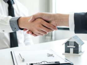 Businessmen and brokers' real estate agents shake hands after completing negotiations to buy houses