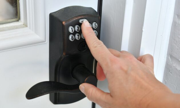 Entering key code PIN on a push button doorknob lock to unlock the door. entering a security code