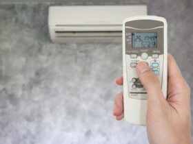 Hand Holding Remote In Front Of Air Conditioner 2022 12 16 03 05 04 Utc