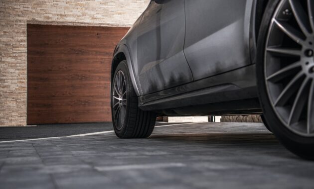 Modern Car on a Driveway in Front of Garage