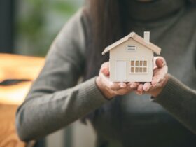 Real estate agent with house plans in hand