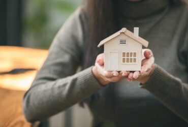 Real estate agent with house plans in hand