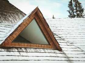 Roof of wooden house with snow in winter day