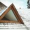 Roof of wooden house with snow in winter day