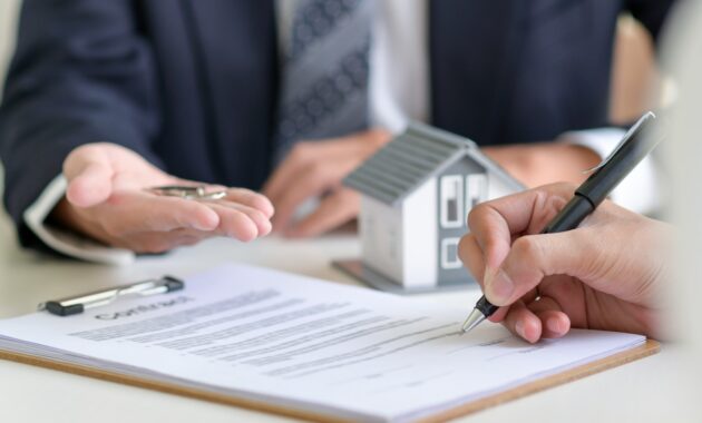 Signing a loan for a home purchase.