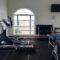 Sport training equipment in a home gym, elliptical cross trainer, ping pong table, indoor gym, home