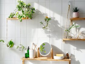 White tile wall with woonden shelves and comstics on them