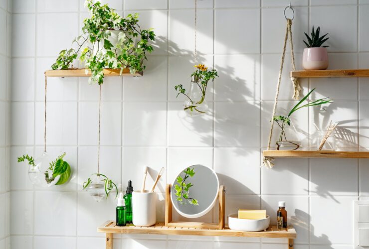White tile wall with woonden shelves and comstics on them