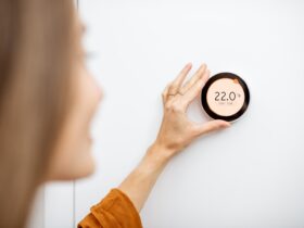 Woman Regulating Heating Temperature At Home 2021 09 01 14 47 59 Utc