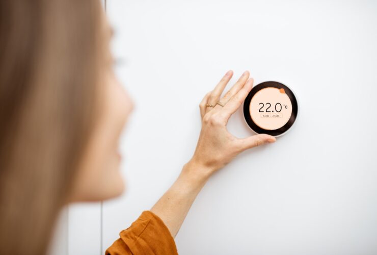 Woman Regulating Heating Temperature At Home 2021 09 01 14 47 59 Utc