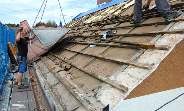 Builder Removing Old Roof Tiles From An Open Roof 2023 05 13 03 25 19 Utc