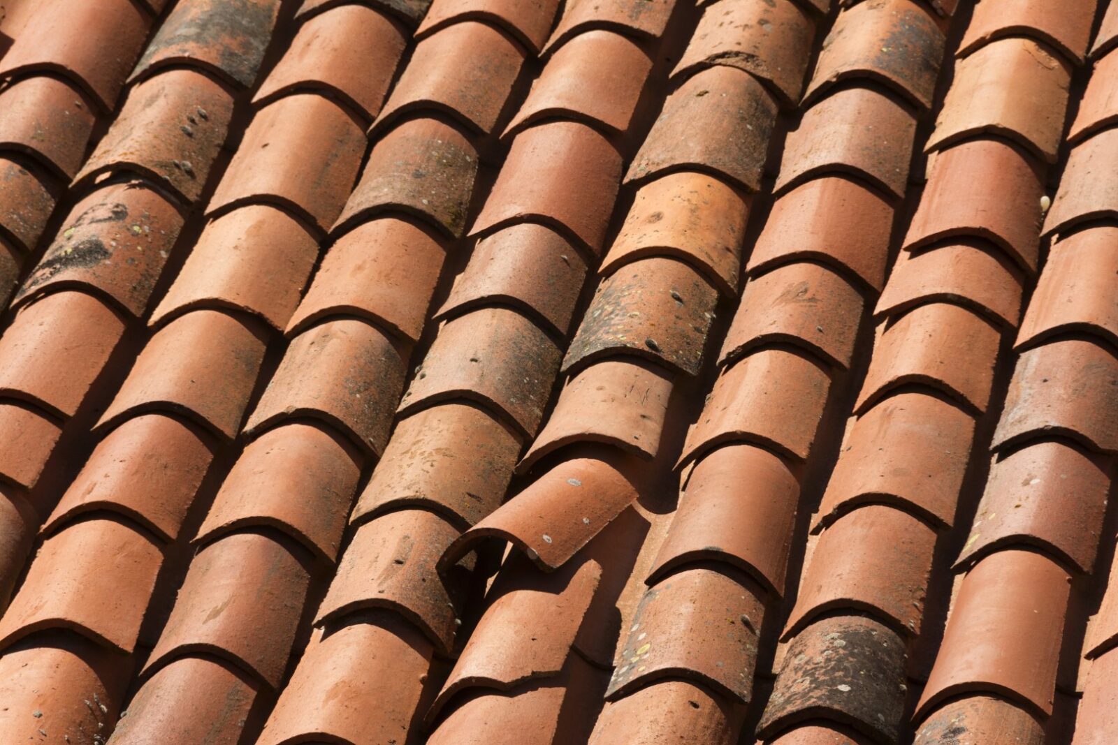 Closeup Shot Of A Red Tiled Roof With A Damaged Su 2022 12 31 04 16 53 Utc