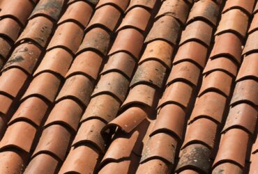 Closeup Shot Of A Red Tiled Roof With A Damaged Su 2022 12 31 04 16 53 Utc