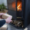 Hands kindle the hearth with economical briquettes