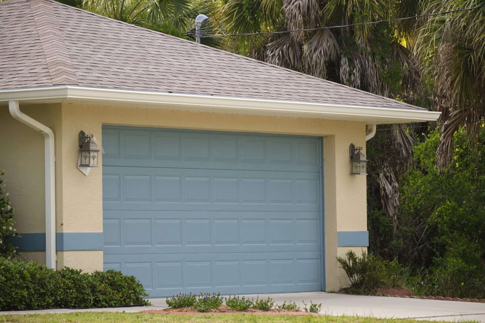 Wide garage double door and concrete driveway of new modern american house