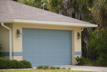Wide garage double door and concrete driveway of new modern american house