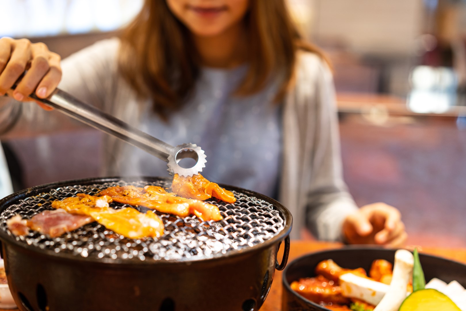 Young Asian Eating Korean Barbecue Yakiniku In Res 2021 10 06 09 53 05 Utc