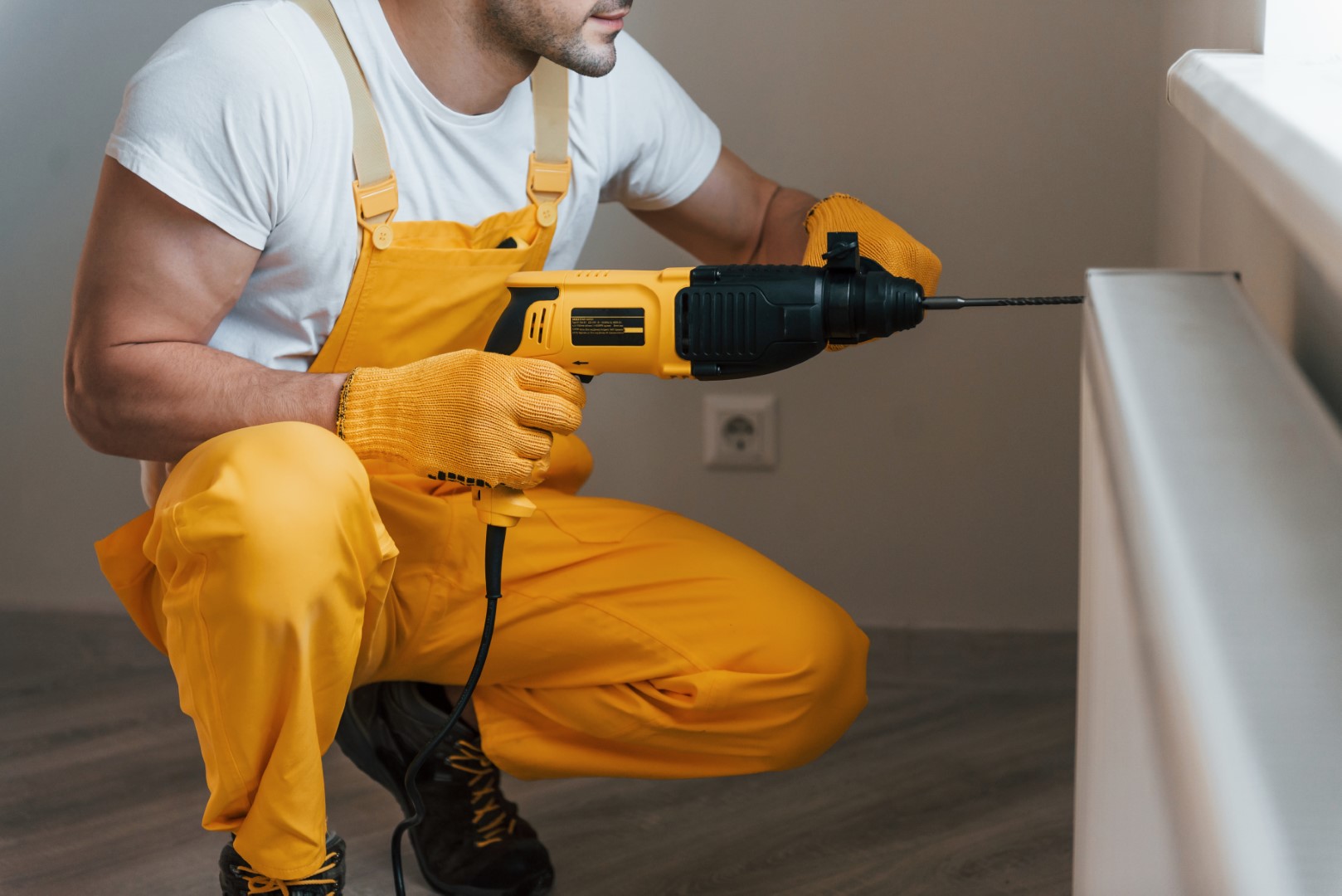 Handyman In Yellow Uniform Works With Drill Indoor 2021 09 01 02 49 46 Utc