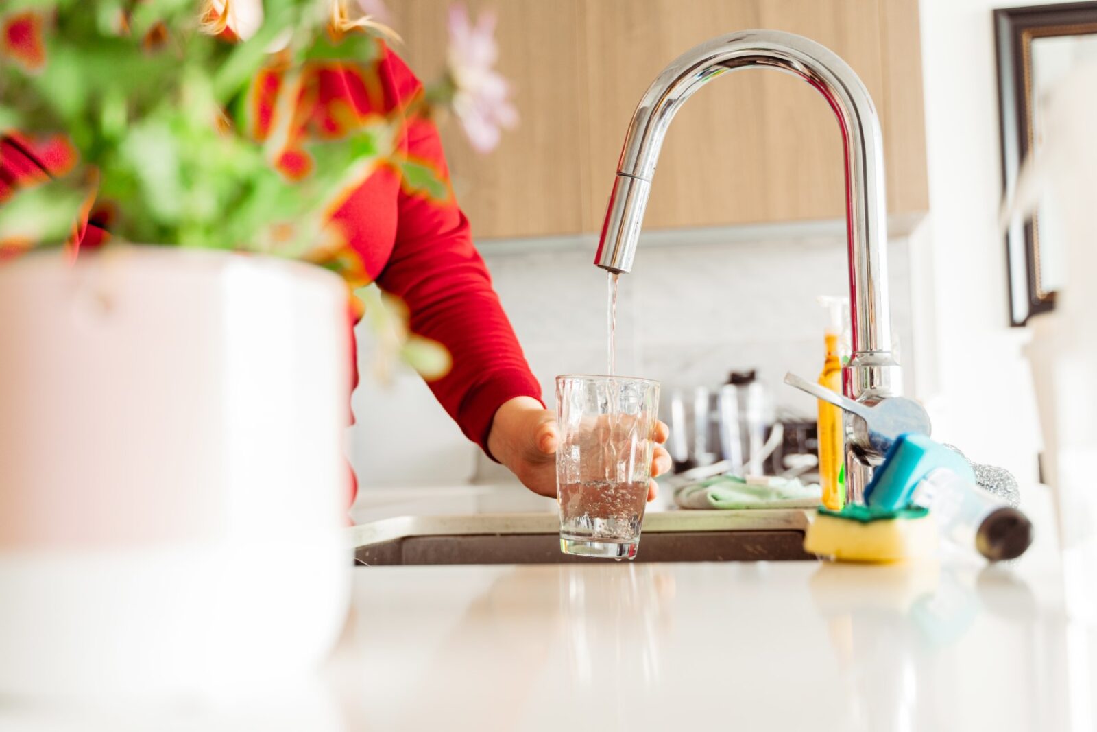 Woman Pouring Tap Water Into Glass In Stylish Kitc 2023 10 31 03 31 39 Utc