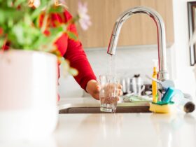 Woman Pouring Tap Water Into Glass In Stylish Kitc 2023 10 31 03 31 39 Utc