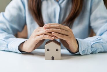 Young Woman Hands Protecting Miniature House Home 2022 01 11 21 49 56 Utc