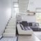 Large, modern sofa in a white living room interior with natural