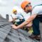 selective focus of handsome handyman repairing roof with coworker